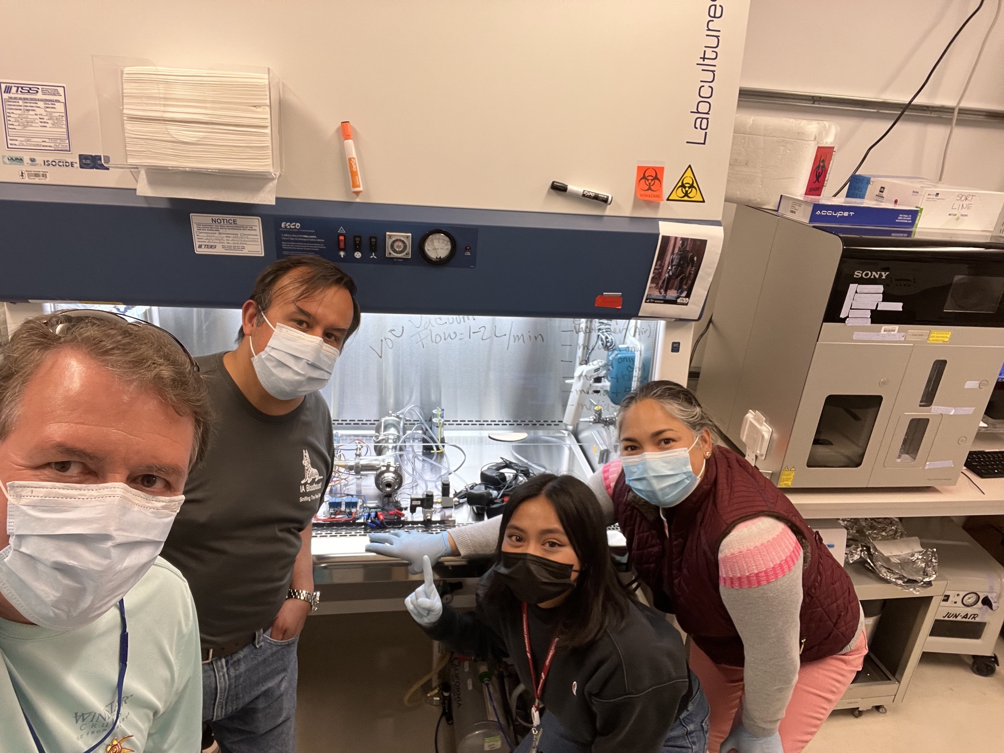 Lab members in front of the biosafety cabinet